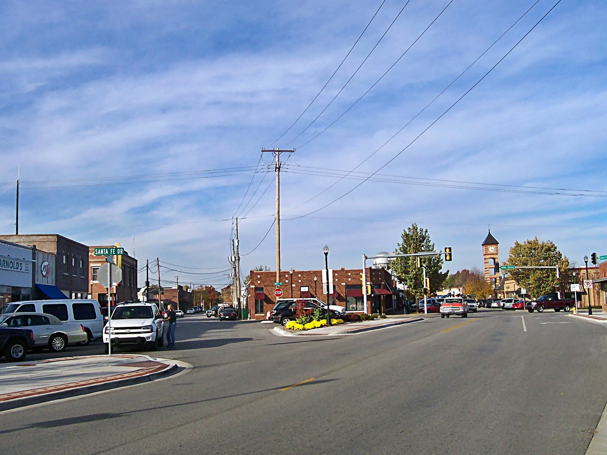 Santa Fe Dr. in downtown Overland Park with brick storefronts, autumn trees and the clock tower in the distance