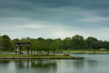 South Lake Park pond in Overland Park with a picnic shelter and trees