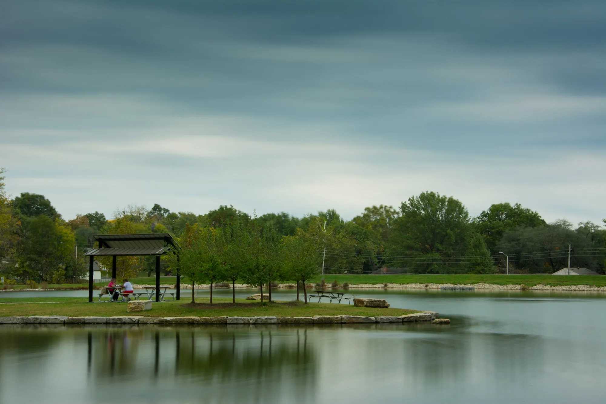 South Lake Park pond in Overland Park with a picnic shelter and trees